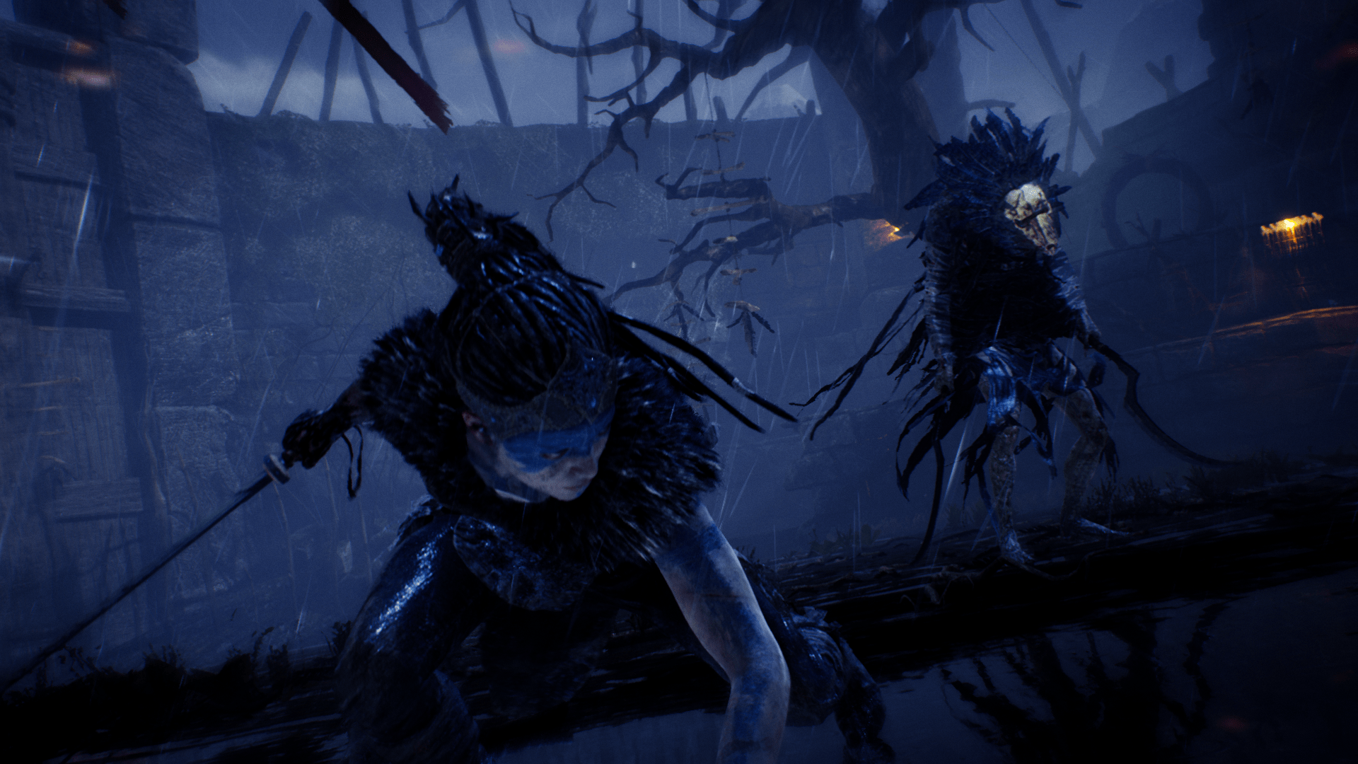 A screenshot showing a dark, rainy arena with a woman fighting a mysterious entity.  The woman is facing towards the camera with her sword held behind her and her other arm on the ground; she's in a sort of recovery pose.  Behind her is a vaguely bird-like entity with a skull for a face, lots of feathers around their head, and a large sickle-like weapon in each hand.